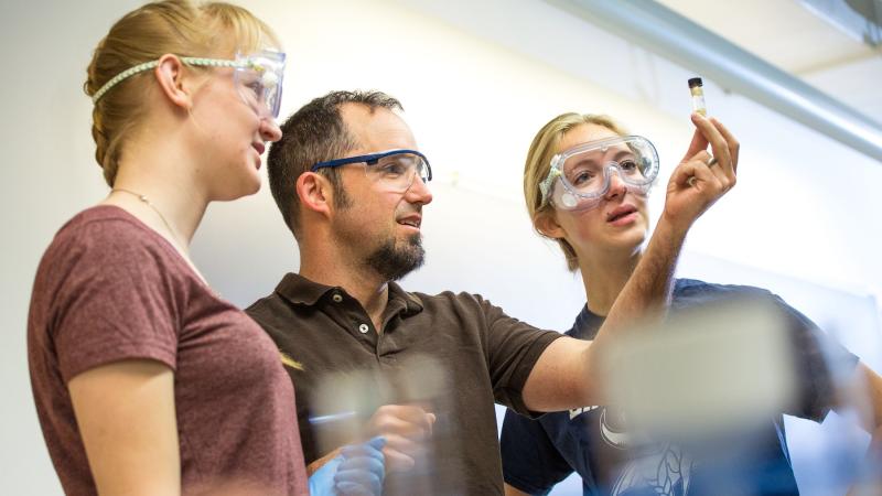 Students work with chemistry professor Stefan Gebbert in class.