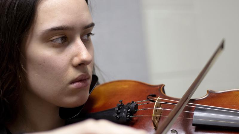 Rehanna Rexroat '20 plays the violin during a recent rehearsal session in Shattuck Hall.
