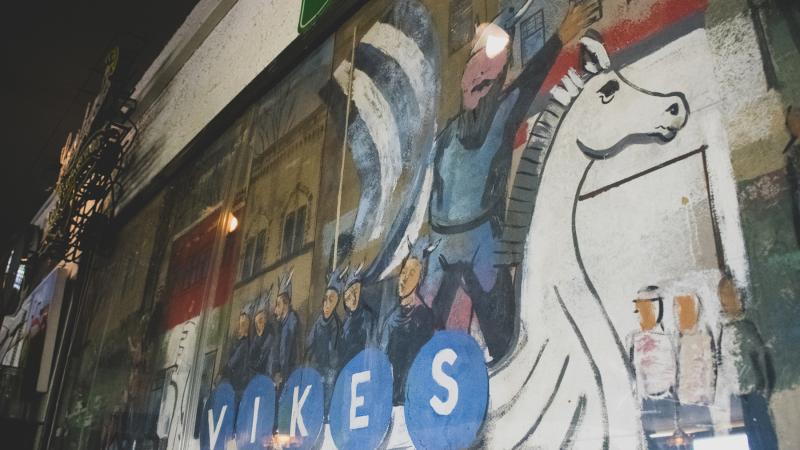 Artwork with a viking sailboat with "VIKES" seen in the Viking Room
