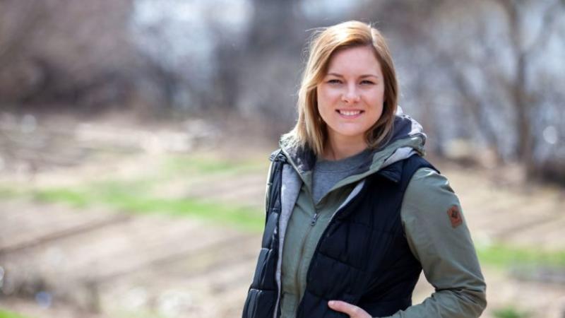 Kelsey McCormick poses for a photo overlooking the SLUG garden.