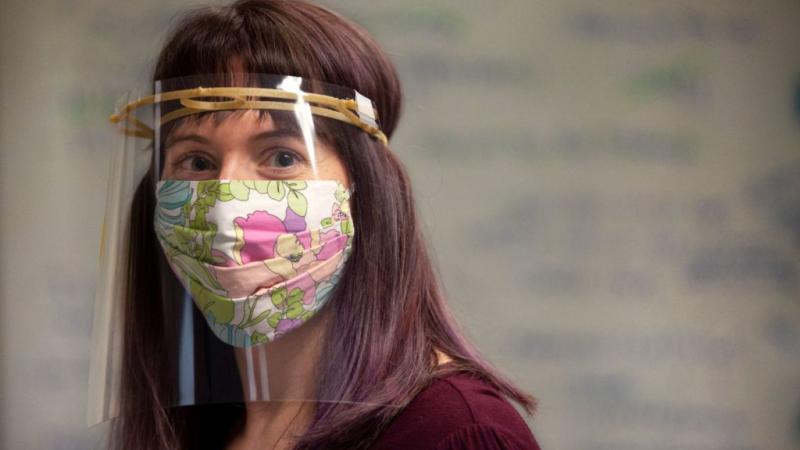 Angela Vanden Elzen models one of the face shields built with 3D printers in Lawrence University’s Makerspace