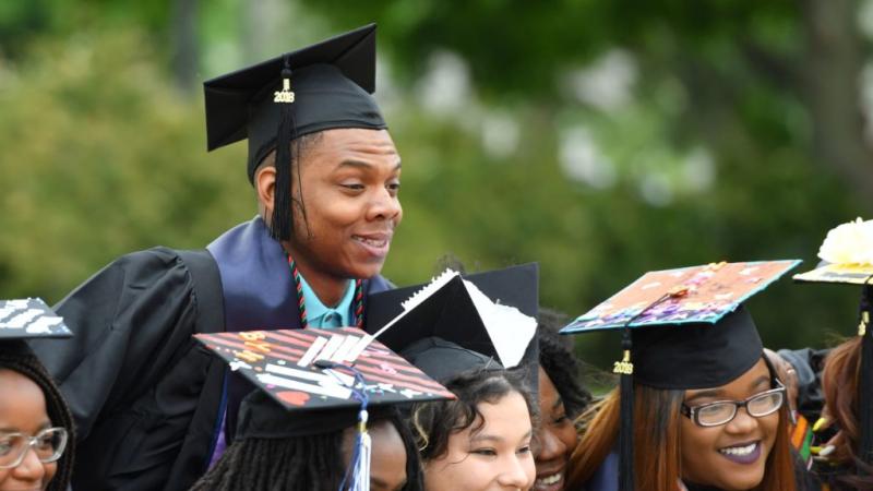 Students posing for pictures at graduation