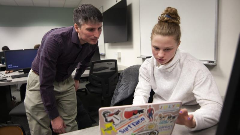 Andrew Sage, assistant professor of statistics, works with Erin Lengel in a Data-Scientific Programming class during Winter Term. 