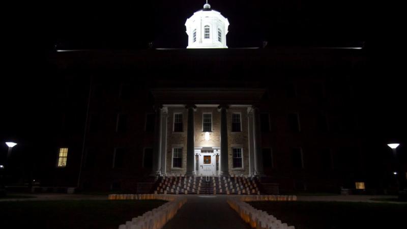 Luminaries line the walkway and steps in front of Main Hall Sunday night. (Photos by Danny Damiani)