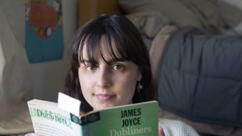 Isabella Mariani looks up from reading James Joyce's "Dubliners."