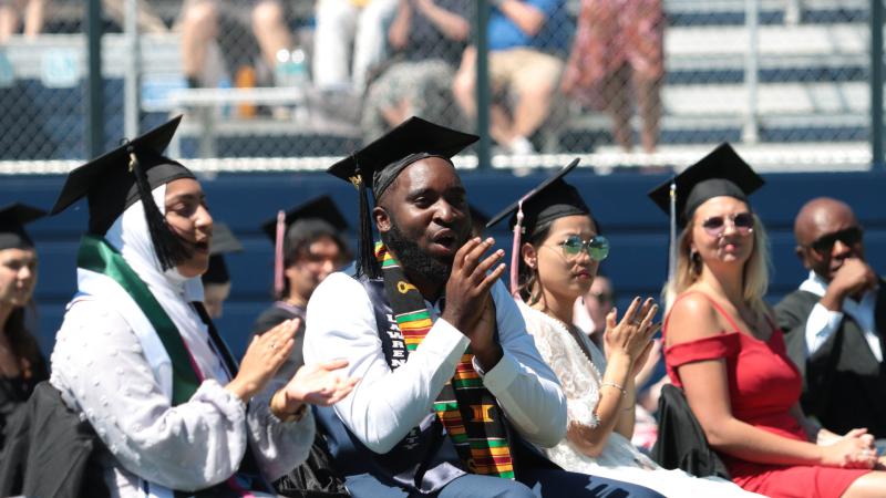 Graduates cheering after ceremony in Banta Bowl