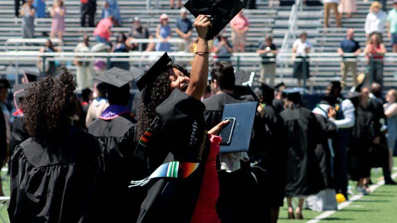 Graduate showing happiness after graduating ceremony in Banta Bowl, June 2021.