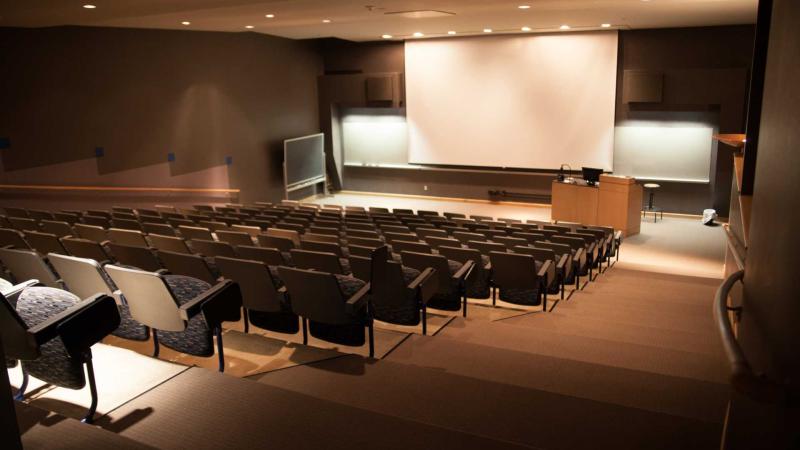 Empty auditorium with lowered projection screen
