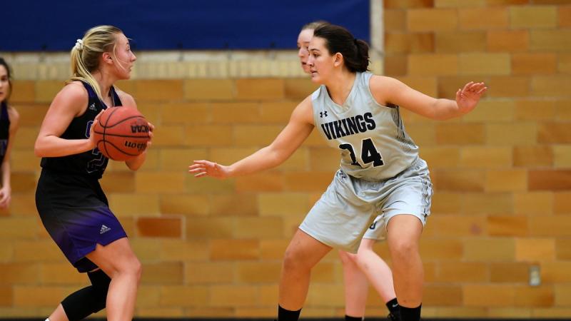 Student Karina Herrera in the middle of a basketball game 