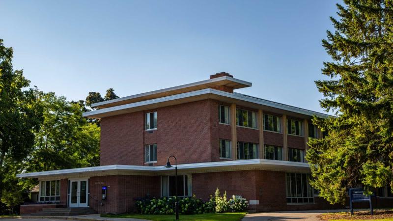 3-story tall red brick building with protruding flat roof 