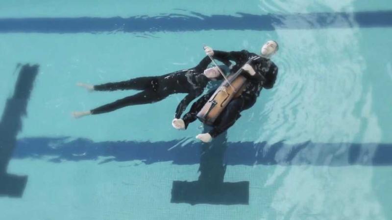 Gabriel Forestieri and Loren Kiyoshi Dempster float in the water while performing “Breathe,” a water opera.