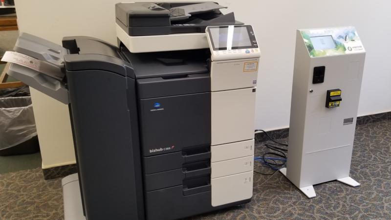 Copy machine with a print release vend unit to the right.