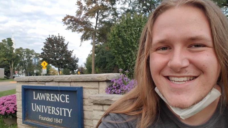 Harris Marks poses in front of a Lawrence University sign.