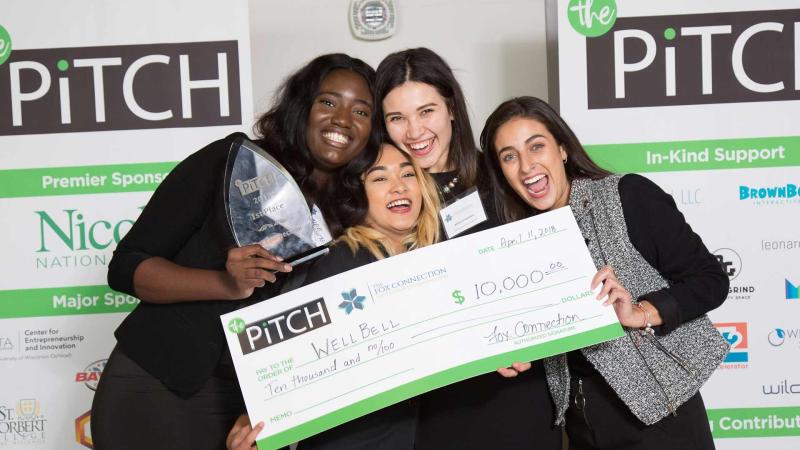 Lawrence students won first place at The Pitch. They are posing with their trophy.