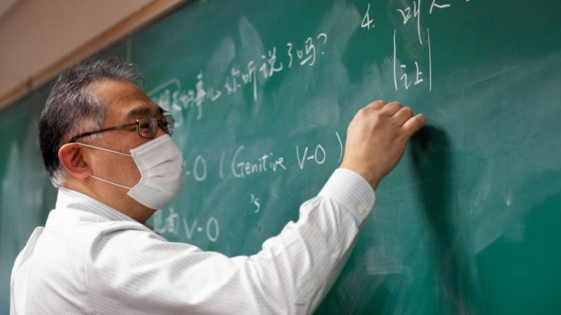 Kuo-ming Sung, Wendy and K.K. Tse Professor of East Asian Studies, writes on blackboard during Intermediate Chinese