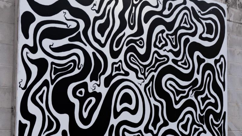 a black and white mural of various shapes and lines