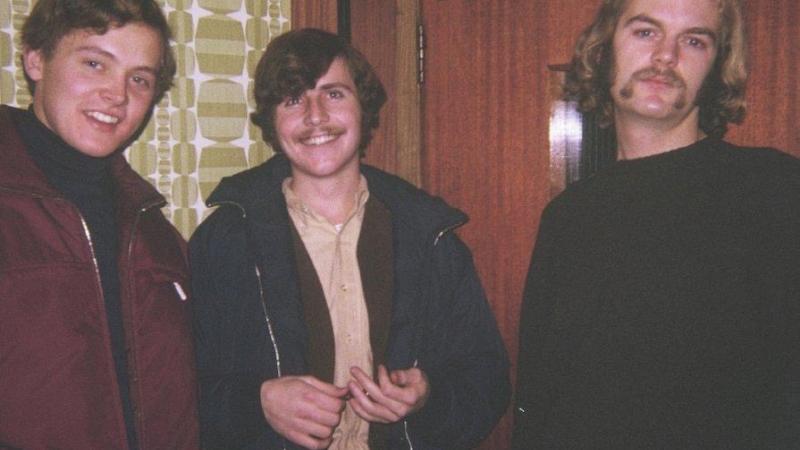 3 men smiling for a photo in 1970.