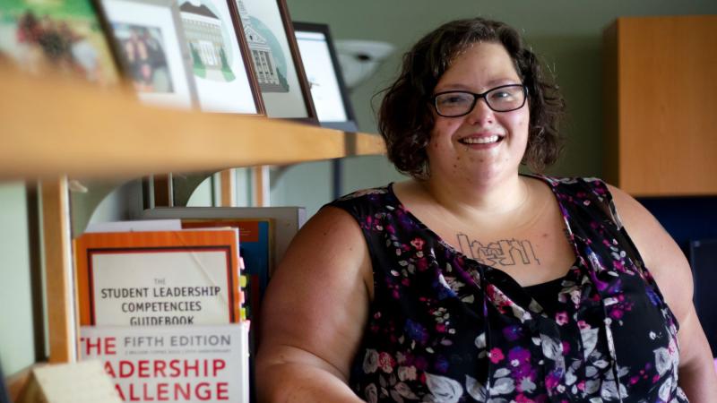 Rose Wasielewski posing next to a bookshelf