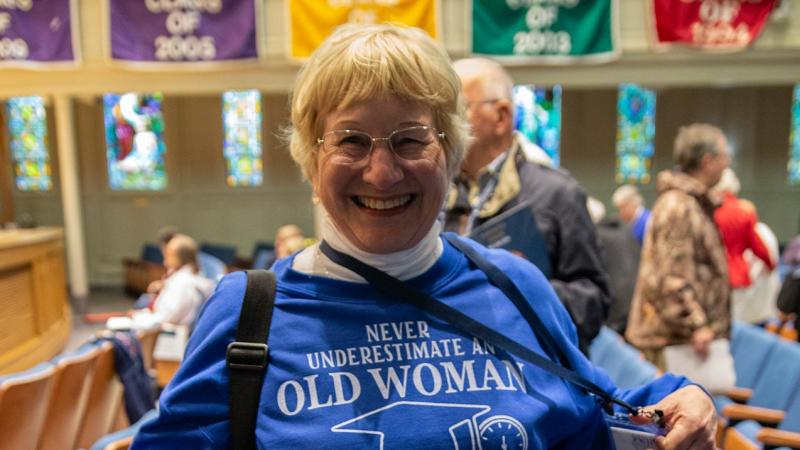 Women wearing a shirt that reads, "Never underestimate an old woman who graduated from Lawrence University"