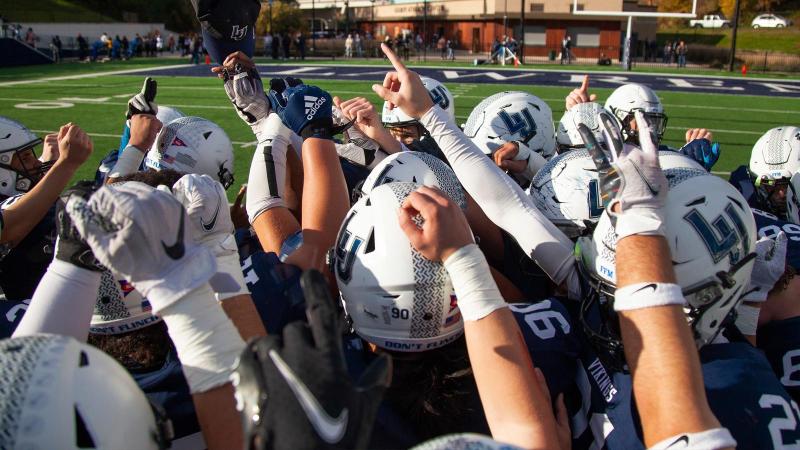 Lawrence University in the huddle after the teams win against Beloit College