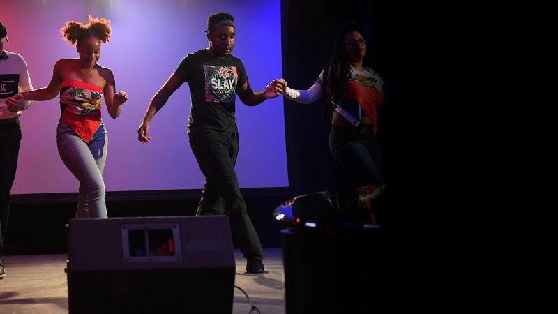 Students dancing on stage during the Cultural Expressions event
