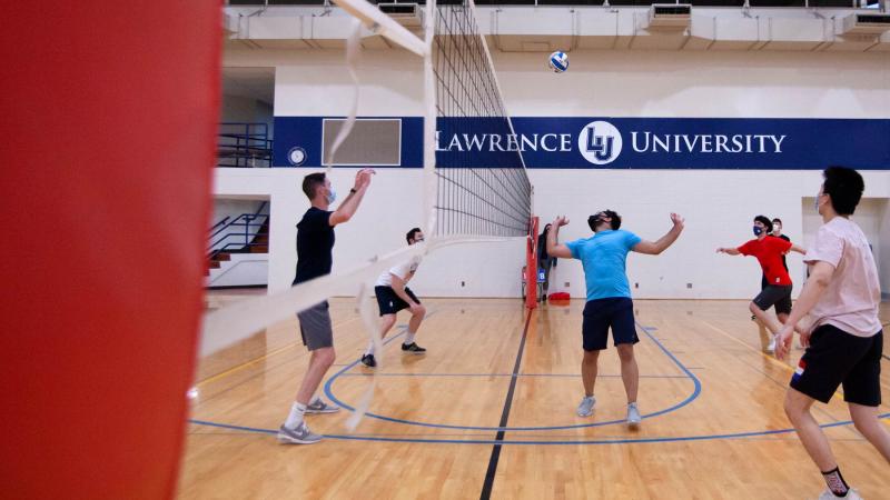 Students playing intramural volleyball in a gym