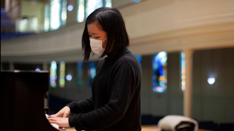 Student plays piano in Memorial Chapel