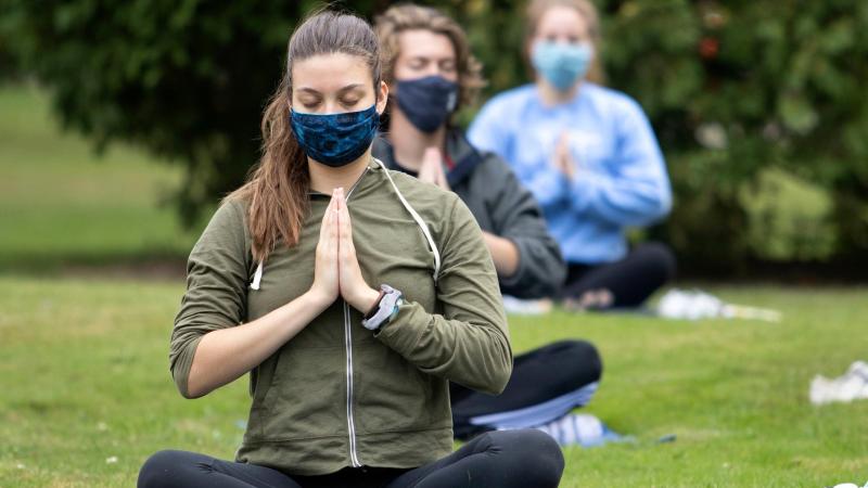 Students participate in outdoor yoga class.