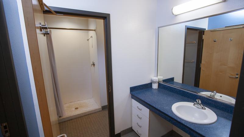Shared bathroom in Hiett double room with single sink and shower stall.