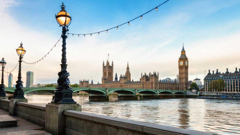 Image of a light post with a bridge in the background in London