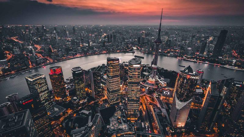 Aerial of Huangpu River cutting through Shanghai, China during sunset