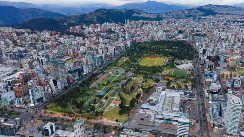 Aerial view of a large public park in Quito, Ecuador surrounded by buildings in the mountains