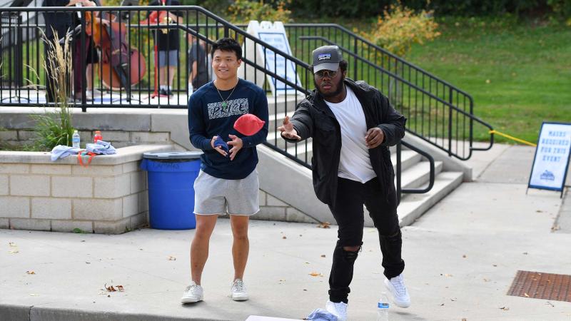 Students playing bag toss outside the Banta Bowl