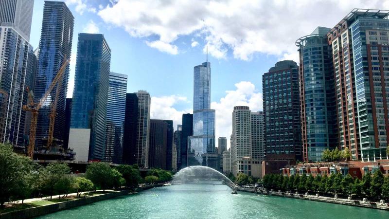 Chicago River with buildings on either side on a sunny day