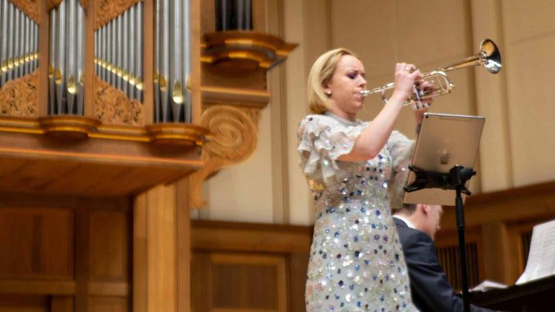 Image of a person playing the trumpet on the Lawrence Chapel stage