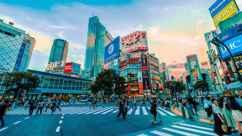 Busy crosswalk in Tokyo as sun's setting