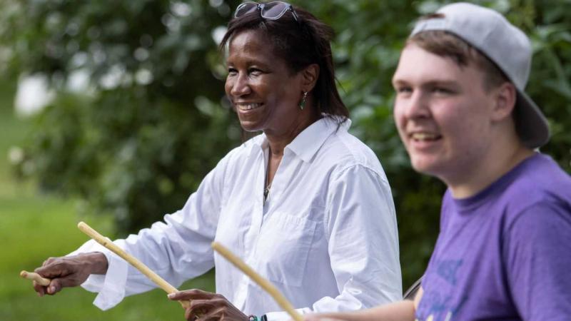 President Laurie Carter joins a percussion session during Mile of Music.