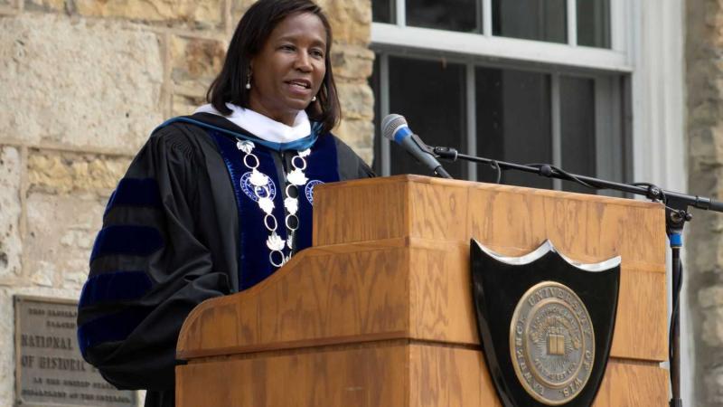 President Laurie Carter speaks to new students and their families in front of Main Hall.