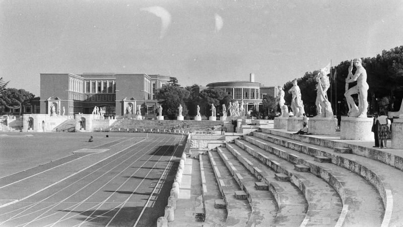 Track surrounded by steps and statues.