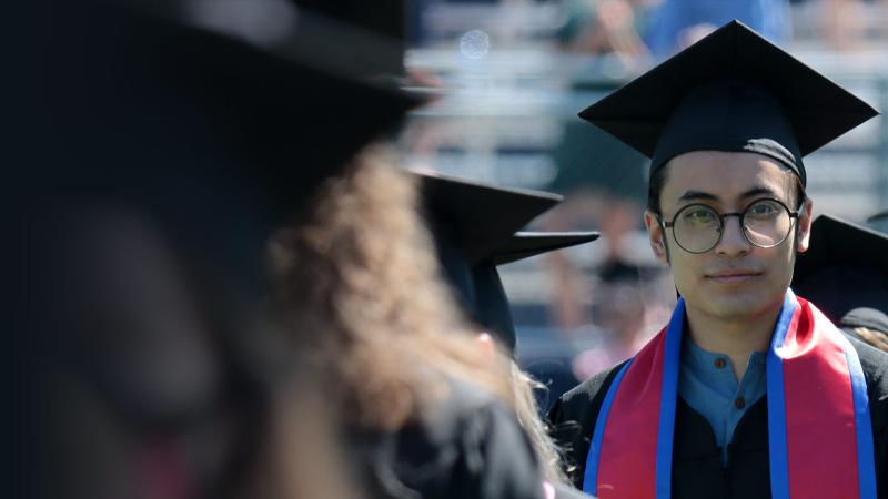Student wearing regalia at Commencement 2021