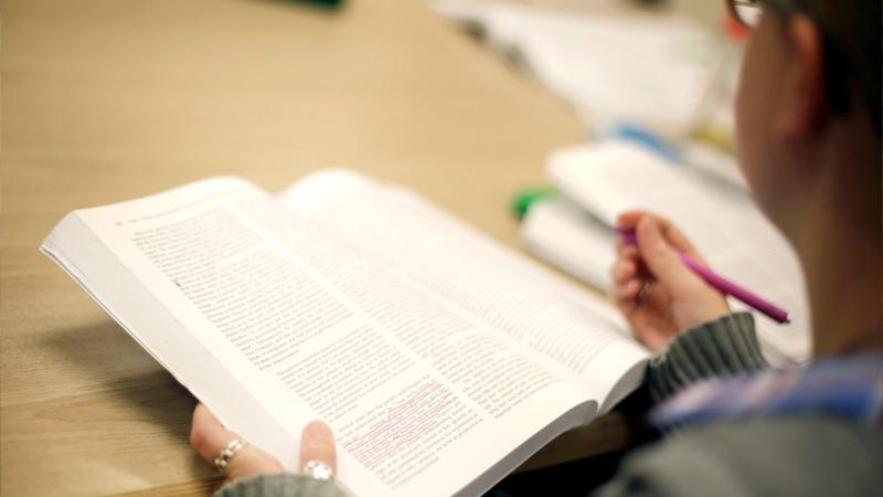 Student highlighting notes in a text book