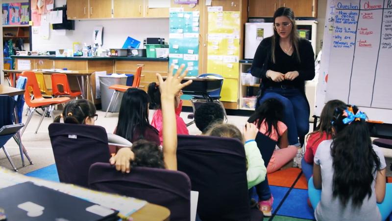 Student leading class discussion at elementary school