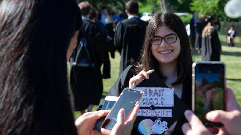 2021 graduate smiles for a portrait