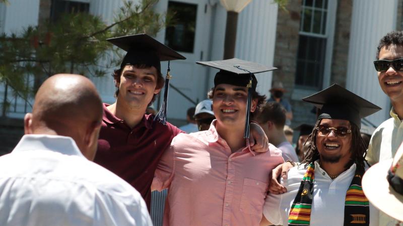 Grads smile for a photo at Commencement 2021