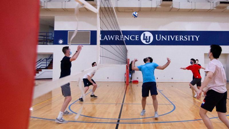 Students playing intramural volleyball in a gym
