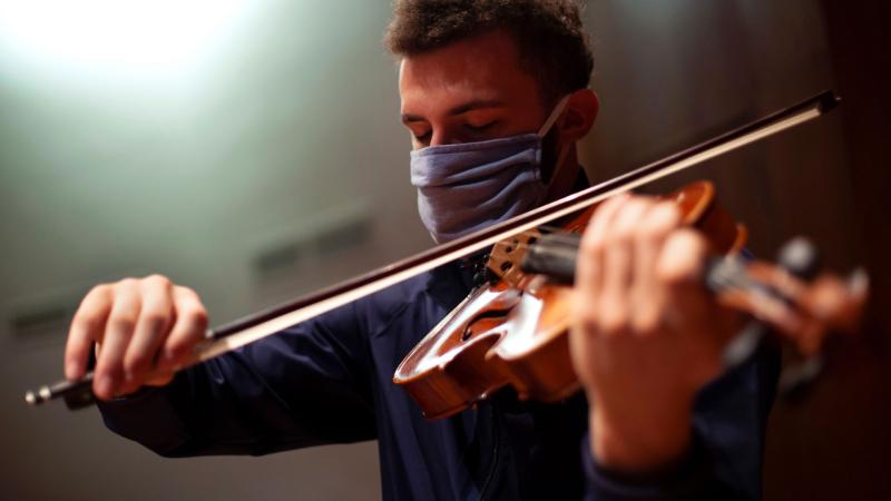 Student plays viola on stage