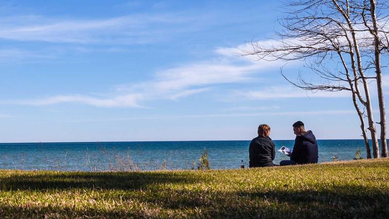 Students chat near Lake Michigan at Bjorklunden