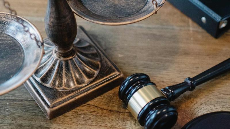 Gavel and scale on a wooden desk