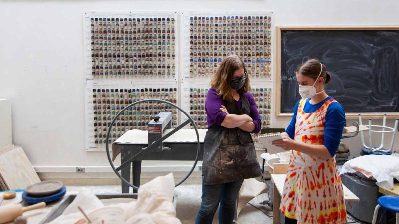 Student and professor in art studio.