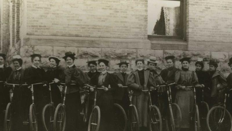 Women standing in a row with their bicycles 